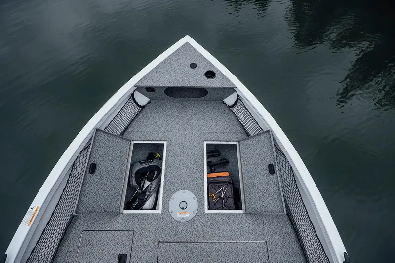 Slide: The Image of Manufacturer Provided Image: 2026 Crestliner 1850 Kodiak WT boat interior with open storage compartments on calm water. - 3