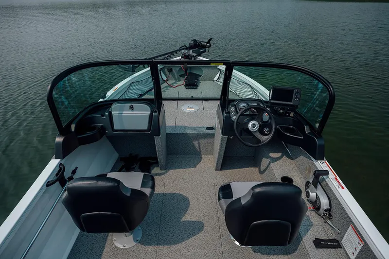 Slide: The Image of Manufacturer Provided Image: 2026 Crestliner 1850 Kodiak WT boat interior with steering wheel and seating on calm water. - 5