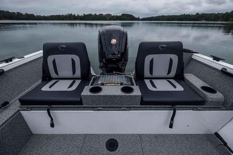 Slide: The Image of Manufacturer Provided Image: 2026 Crestliner 1850 Kodiak WT boat interior with dual seats and motor on a calm lake. - 7