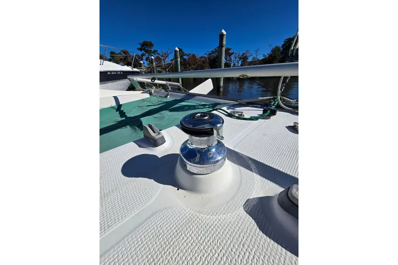 Slide: The Image of 1985 Sea Wind 24 sailboat deck with winch, docked on a sunny day. - 12