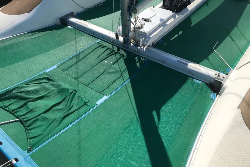 Slide: The Image of 1985 Sea Wind 24 sailboat deck with green netting and rigging. - 17