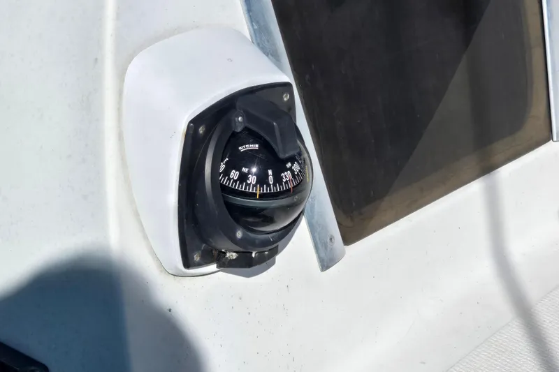 Slide: The Image of Compass on 1985 Sea Wind 24 boat, mounted near window, showing navigation details. - 19