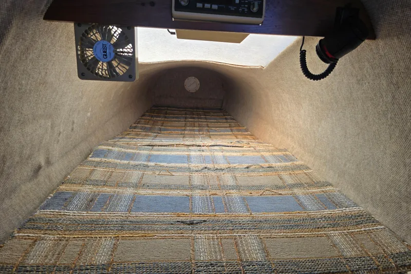 Slide: The Image of Interior cabin of a 1985 Sea Wind 24 sailboat with plaid upholstery and ventilation fan. - 22