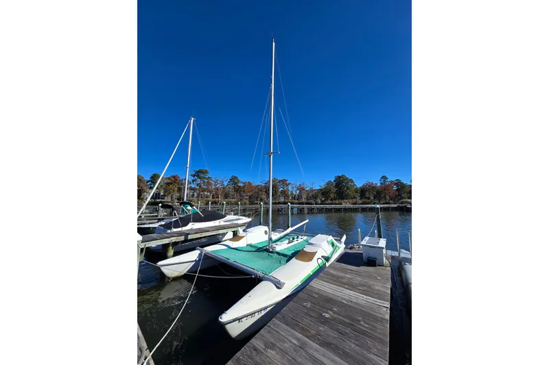 Slide: The Image of 1985 Sea Wind 24 sailboat docked on a sunny day with clear blue sky. - 29