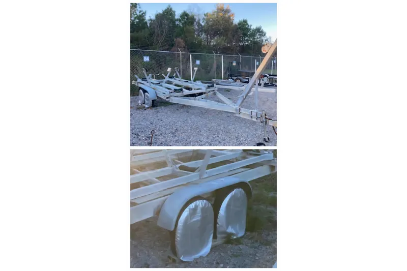 Slide: The Image of Trailer for 1985 Sea Wind 24 boat, parked on gravel with covered wheels. - 8