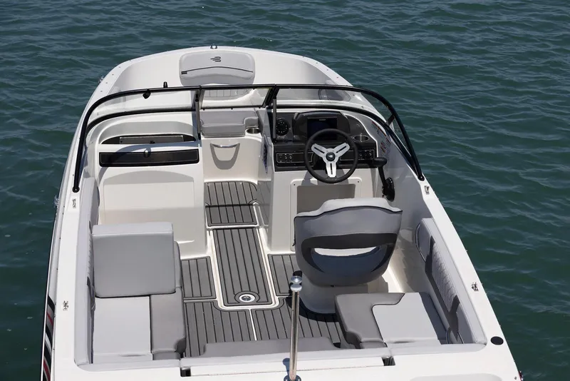 Slide: The Image of 2026 Bayliner VR4 Bowrider OB interior with tan seating and wood-style flooring. - 9