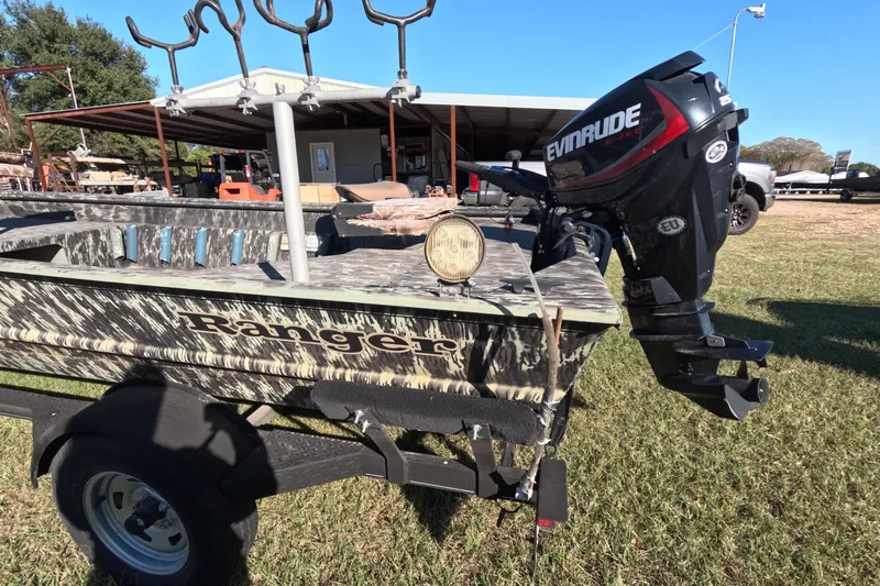 Slide: The Image of 2014 Ranger 1652H MPV boat with Evinrude motor, parked outdoors. - 5