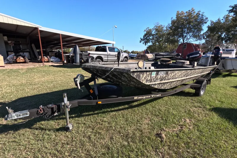 Slide: The Image of 2014 Ranger 1652H MPV boat on trailer, parked on grass near a shed. - 7