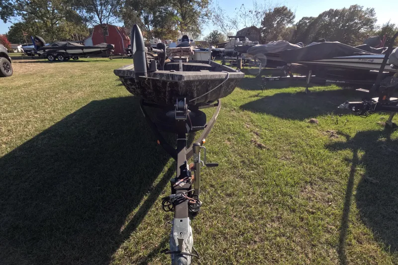 Slide: The Image of 2014 Ranger 1652H MPV boat on trailer, parked on grassy area with other boats. - 8