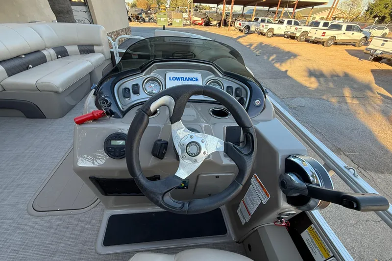 Slide: The Image of 2020 Sun Tracker Fishin' Barge 22 XP3 dashboard with steering wheel and controls. - 10