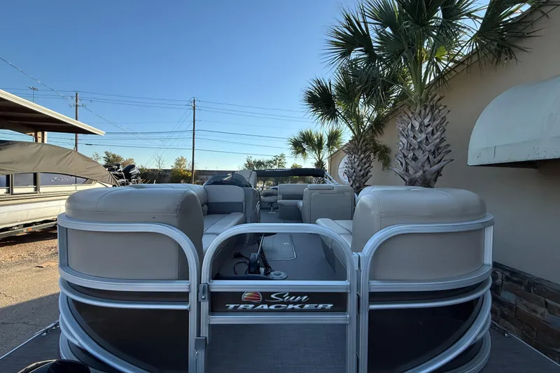 Slide: The Image of 2020 Sun Tracker Fishin' Barge 22 XP3 pontoon boat with beige seating and palm trees. - 3