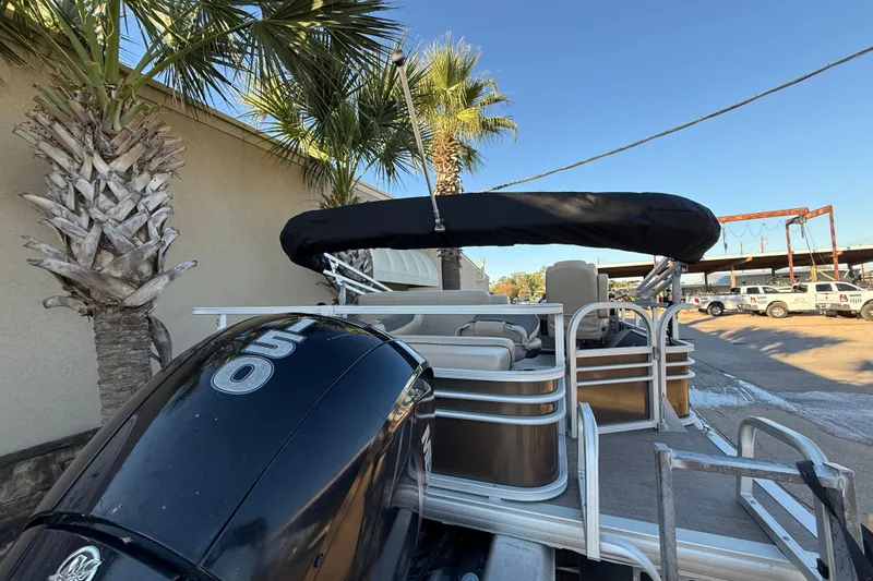 Slide: The Image of 2020 Sun Tracker Fishin' Barge 22 XP3 pontoon boat with 150 HP engine, parked outdoors. - 5