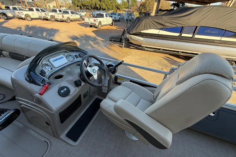 Slide: The Image of 2020 Sun Tracker Fishin' Barge 22 XP3 helm with steering wheel and comfortable captain's chair. - 9