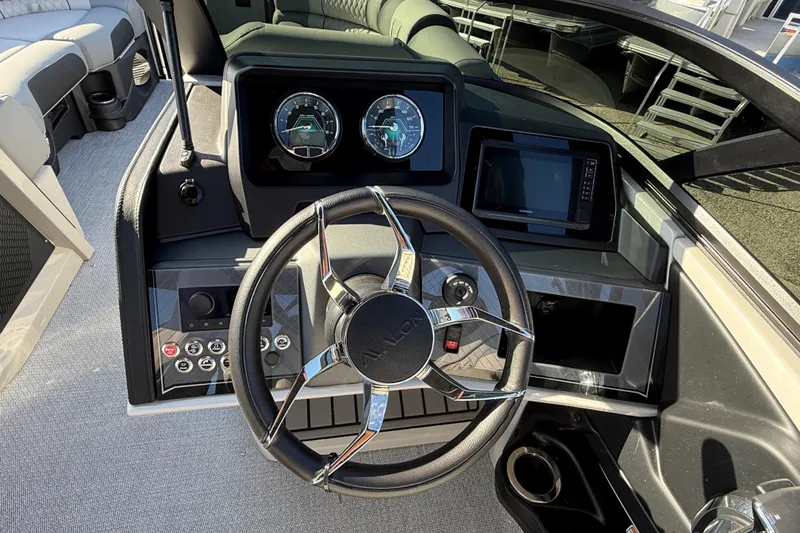 Slide: The Image of Steering console of 2026 Avalon 2585 Catalina Windsheild Quad Lounger with modern controls and displays. - 22