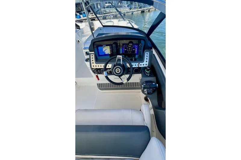 Slide: The Image of 2019 Chaparral 347 SSX boat dashboard with modern navigation controls and steering wheel. - 15