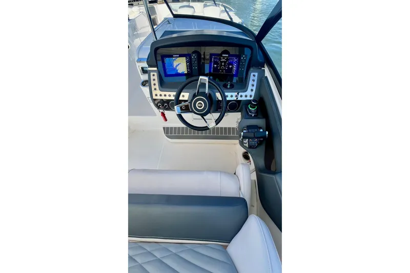 Slide: The Image of 2019 Chaparral 347 SSX boat interior with helm and seating area. - 16