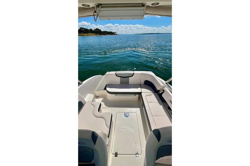 Slide: The Image of 2019 Chaparral 347 SSX boat interior with seating, overlooking a scenic water view. - 18