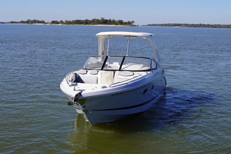 Slide: The Image of 2019 Chaparral 347 SSX boat cruising on a calm lake under clear skies. - 2