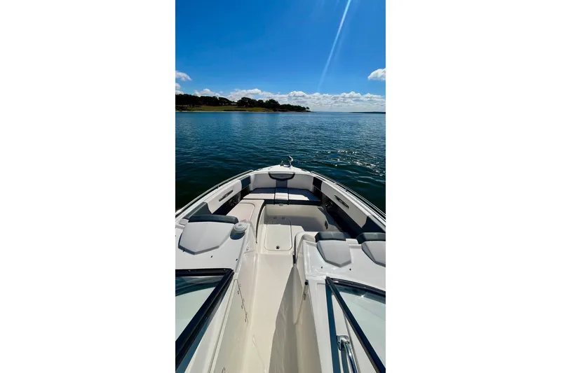 Slide: The Image of 2019 Chaparral 347 SSX boat interior with spacious seating on a sunny lake. - 27