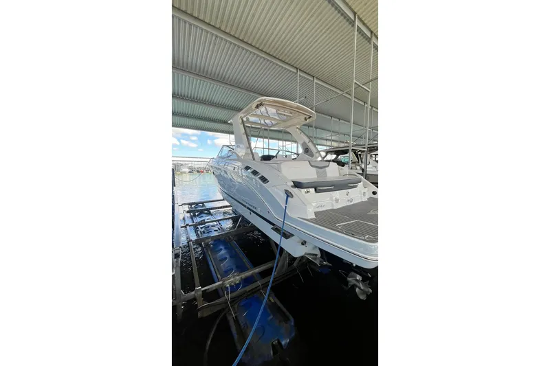 Slide: The Image of 2019 Chaparral 347 SSX boat docked in a covered marina. - 32
