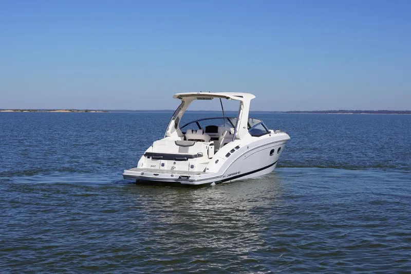 Slide: The Image of 2019 Chaparral 347 SSX boat cruising on open water under clear blue skies. - 6