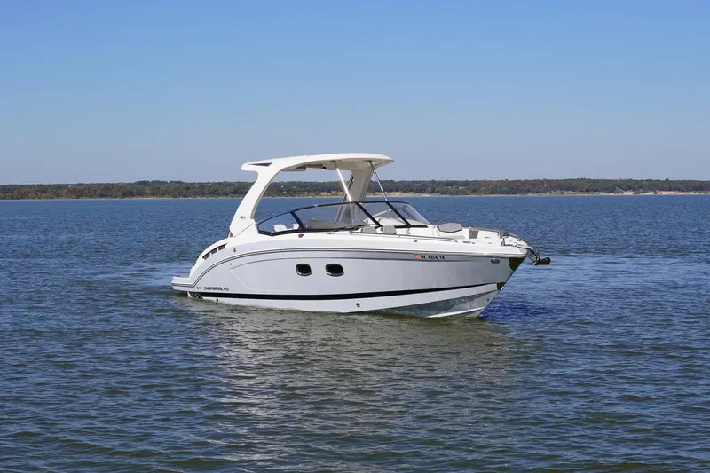 Slide: The Image of 2019 Chaparral 347 SSX boat on calm water under clear blue sky. - 8