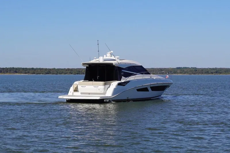 Slide: The Image of 2015 Sea Ray 470 Sundancer yacht cruising on a calm lake. - 10