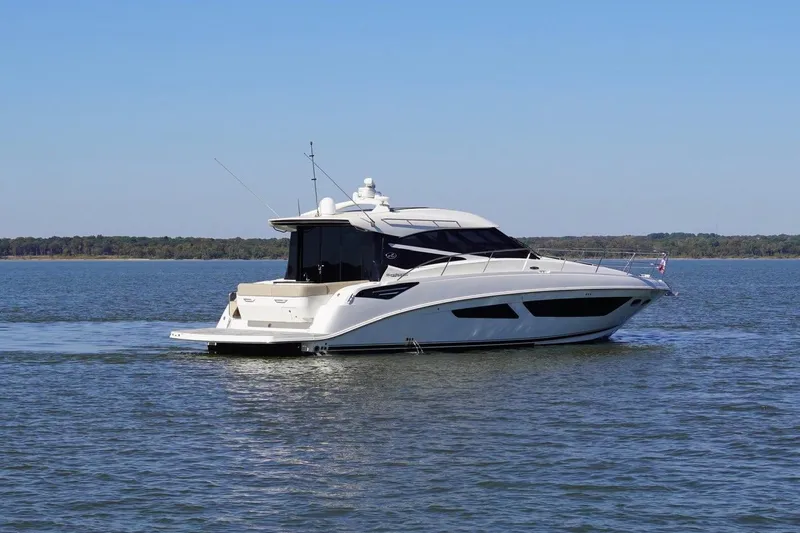 Slide: The Image of 2015 Sea Ray 470 Sundancer yacht cruising on a calm lake under clear skies. - 11