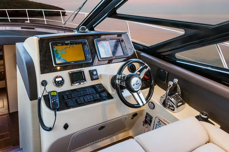 Slide: The Image of Manufacturer Provided Image: Helm station of 2015 Sea Ray 470 Sundancer with navigation screens and controls. - 16