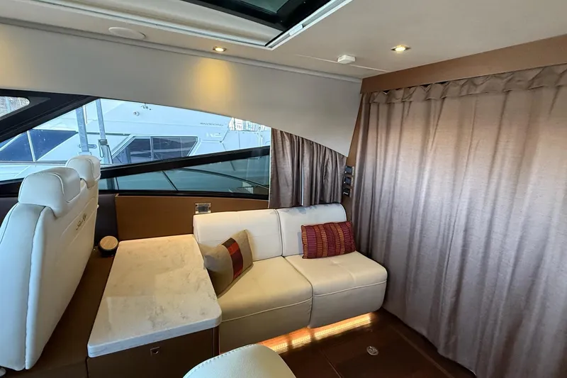 Slide: The Image of Interior of 2015 Sea Ray 470 Sundancer yacht with elegant seating and table. - 23