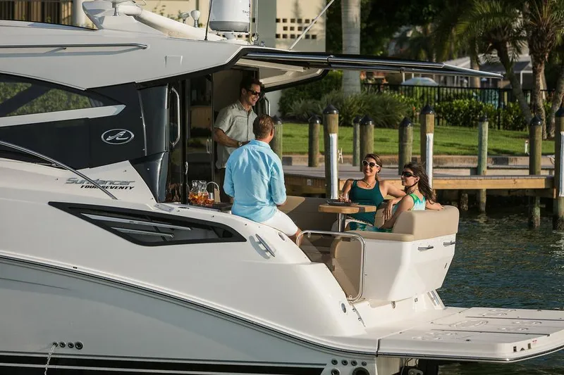 Slide: The Image of 2015 Sea Ray 470 Sundancer yacht cruising on a calm lake under clear skies. - 3