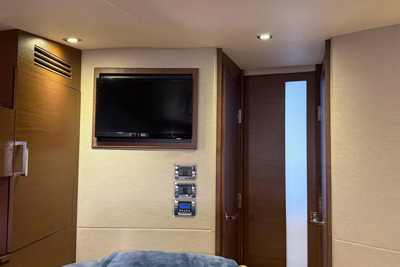 Slide: The Image of Interior of 2015 Sea Ray 470 Sundancer yacht with TV and modern wood paneling. - 33