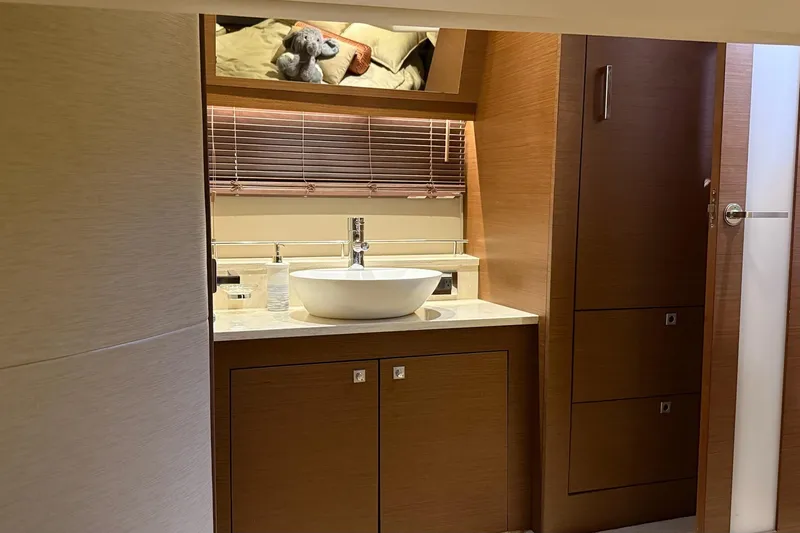 Slide: The Image of Luxurious bathroom interior of 2015 Sea Ray 470 Sundancer yacht with modern sink and wooden cabinetry. - 36