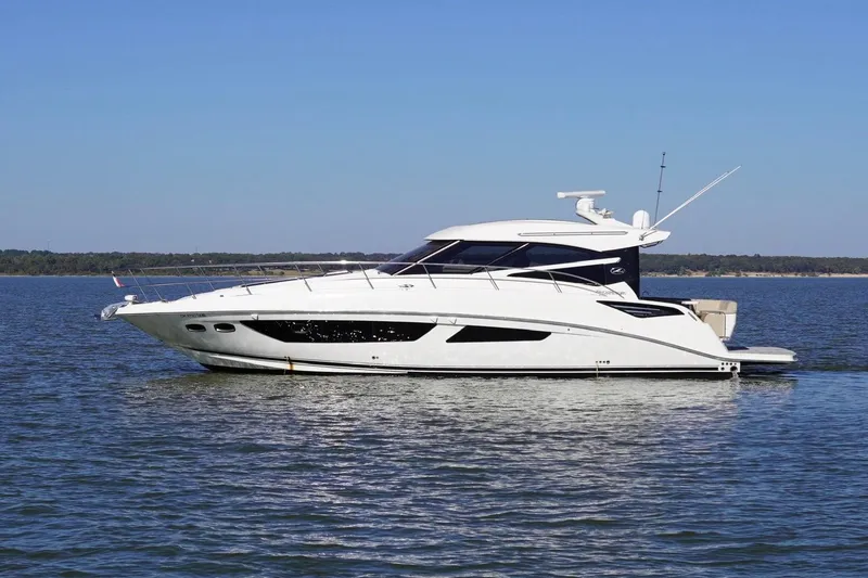 The Image of 2015 Sea Ray 470 Sundancer yacht cruising on calm waters under clear blue skies. - 4