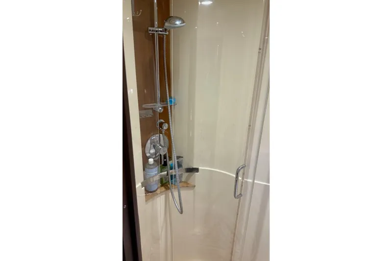 Slide: The Image of Shower area inside 2015 Sea Ray 470 Sundancer yacht, featuring modern fixtures and glass door. - 42