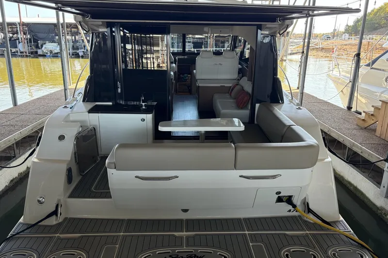 Slide: The Image of 2015 Sea Ray 470 Sundancer yacht with spacious seating and modern interior at dock. - 47