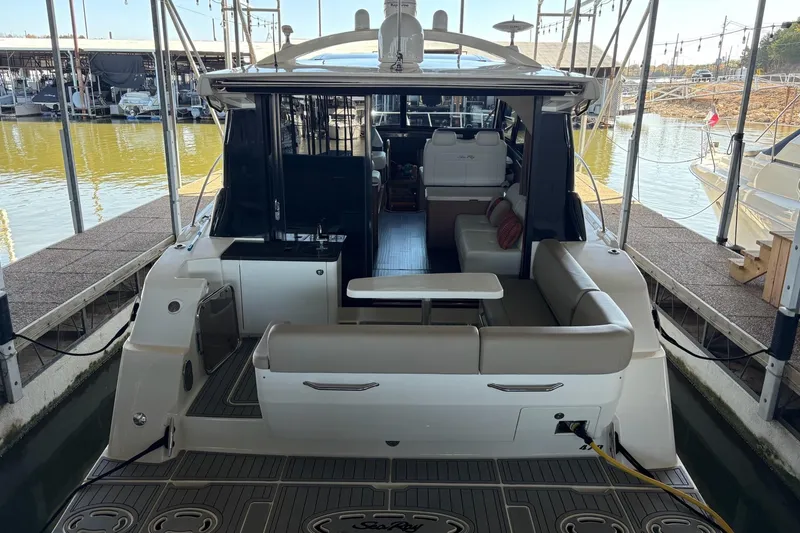 Slide: The Image of 2015 Sea Ray 470 Sundancer yacht docked, featuring spacious seating and modern design. - 48