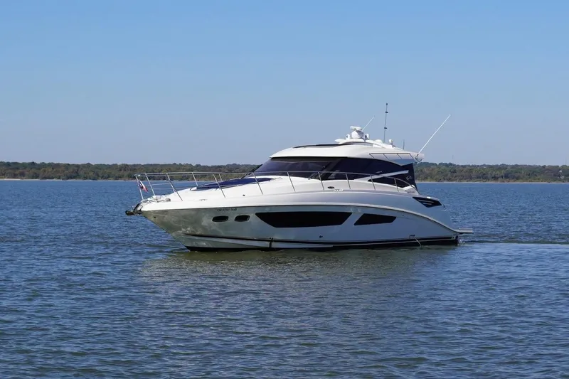 Slide: The Image of 2015 Sea Ray 470 Sundancer yacht cruising on a calm lake under clear skies. - 5
