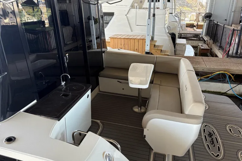 Slide: The Image of 2015 Sea Ray 470 Sundancer yacht interior with seating and kitchenette. - 52