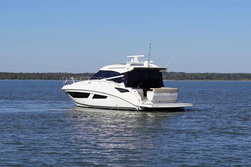 Slide: The Image of 2015 Sea Ray 470 Sundancer yacht cruising on a calm lake. - 7