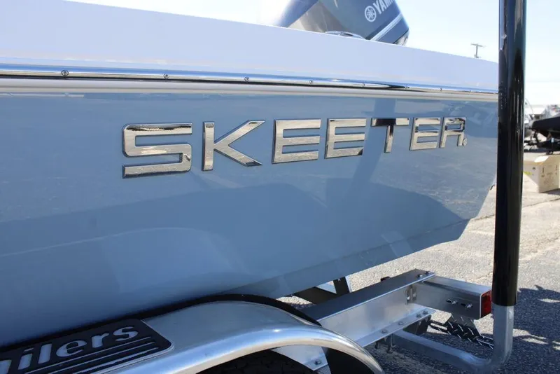 Slide: The Image of 2026 Skeeter SX230 boat on trailer, rear view, parked outdoors. - 25