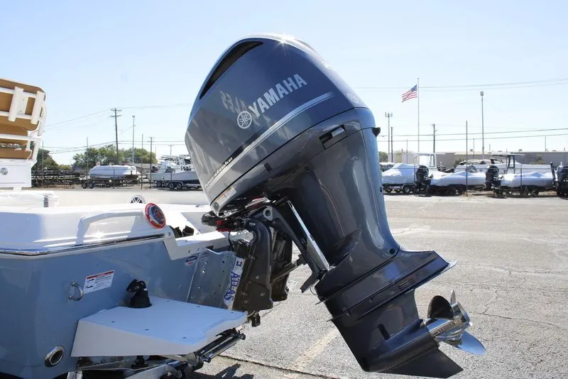 Slide: The Image of 2026 Skeeter SX230 boat on trailer in parking lot, front view. - 3