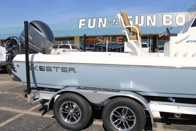Slide: The Image of 2026 Skeeter SX230 boat on trailer at dealership, featuring Yamaha engine. - 6
