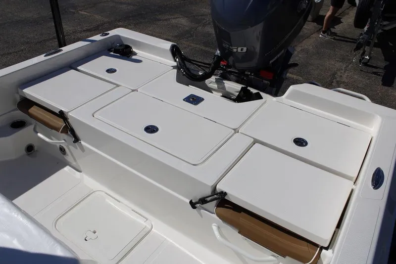 Slide: The Image of 2026 Skeeter SX230 boat with tan seats and outboard motor. - 8