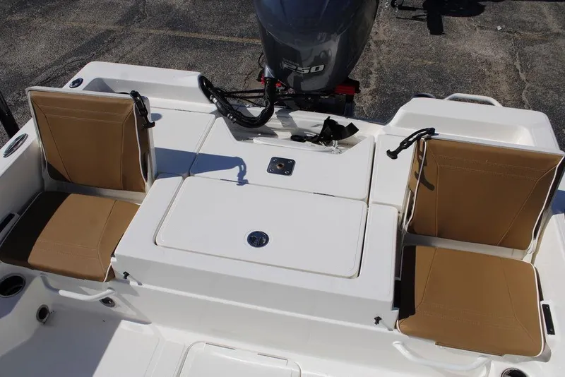 Slide: The Image of 2026 Skeeter SX230 boat with powerful outboard motor in a parking lot. - 9