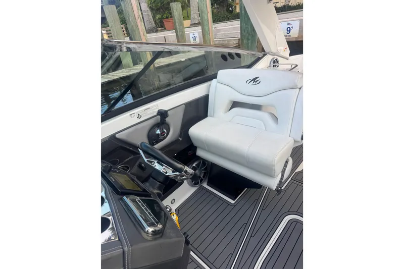 Slide: The Image of 2017 Monterey 298SS Super Sport boat interior with white captain's seat and steering wheel. - 19