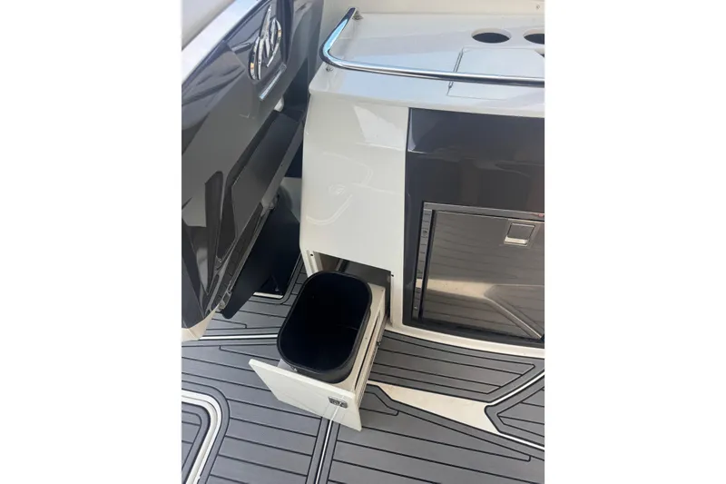 Slide: The Image of 2017 Monterey 298SS Super Sport boat interior with storage compartment and trash bin. - 23