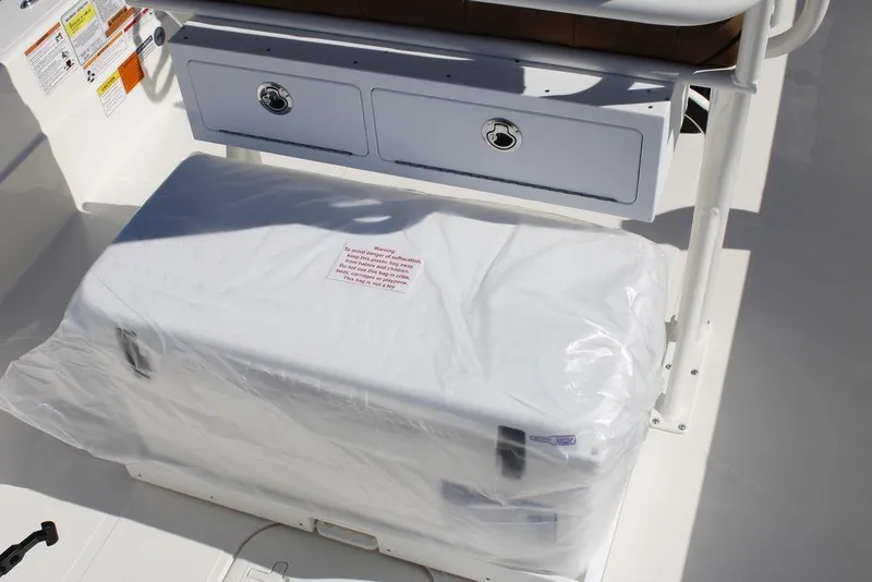 Slide: The Image of 2026 Skeeter SX241 boat interior with storage compartment and protective covering. - 15