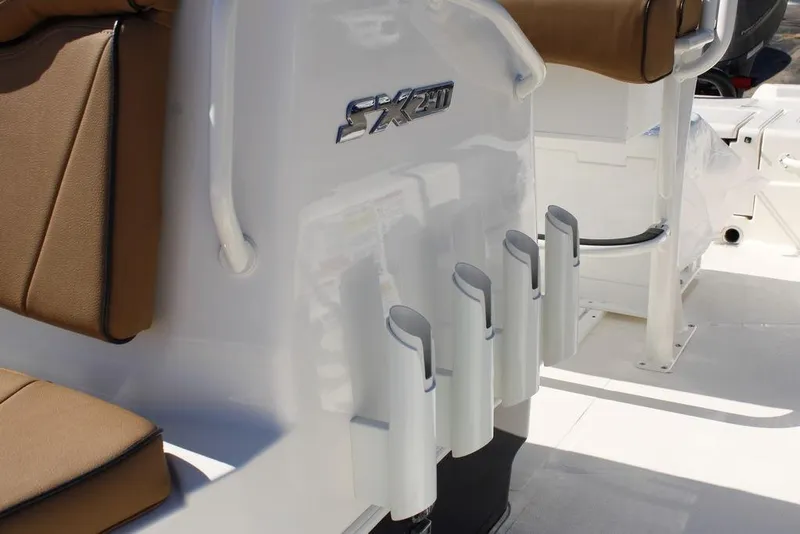 Slide: The Image of 2026 Skeeter SX241 boat interior with rod holders and brown seating. - 20