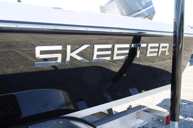 Slide: The Image of 2026 Skeeter SX241 boat with sleek black exterior and chrome logo. - 25